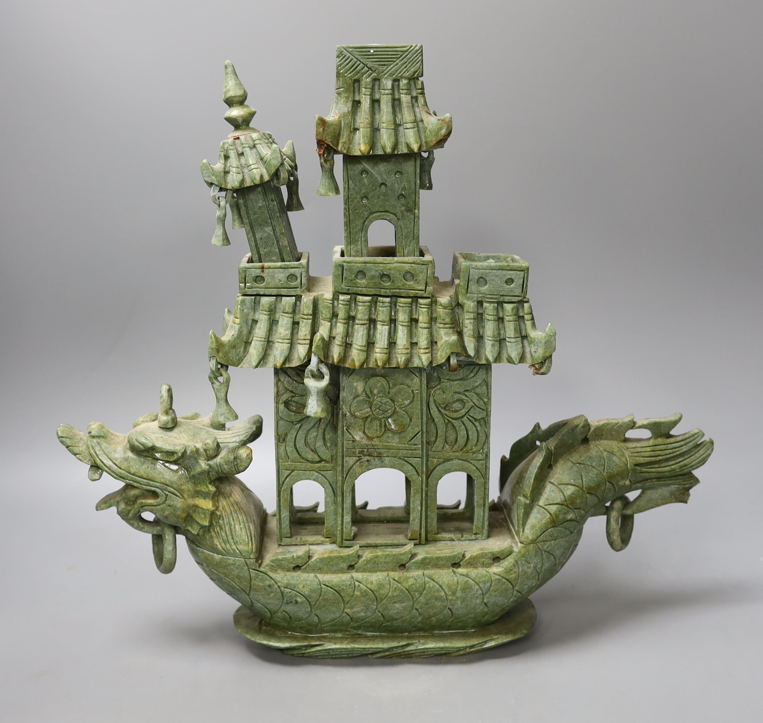 A Chinese hardstone intricately carved model of a boat, with inscription on the flag - 31cm tall